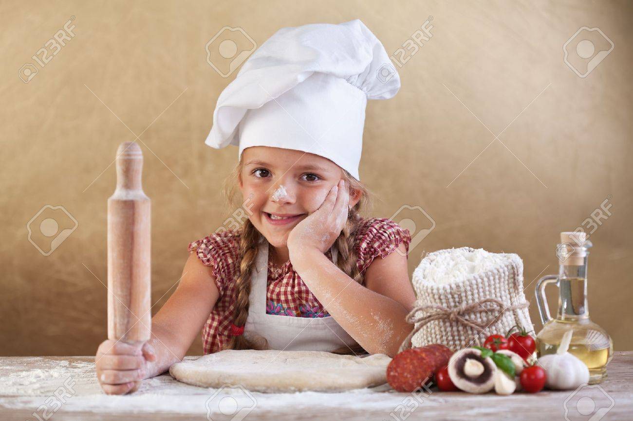Little girl making pizza - preparing the dough and other ingredients - 19614801 Little girl making pizza - preparing the dough and other ingredients - 19614801