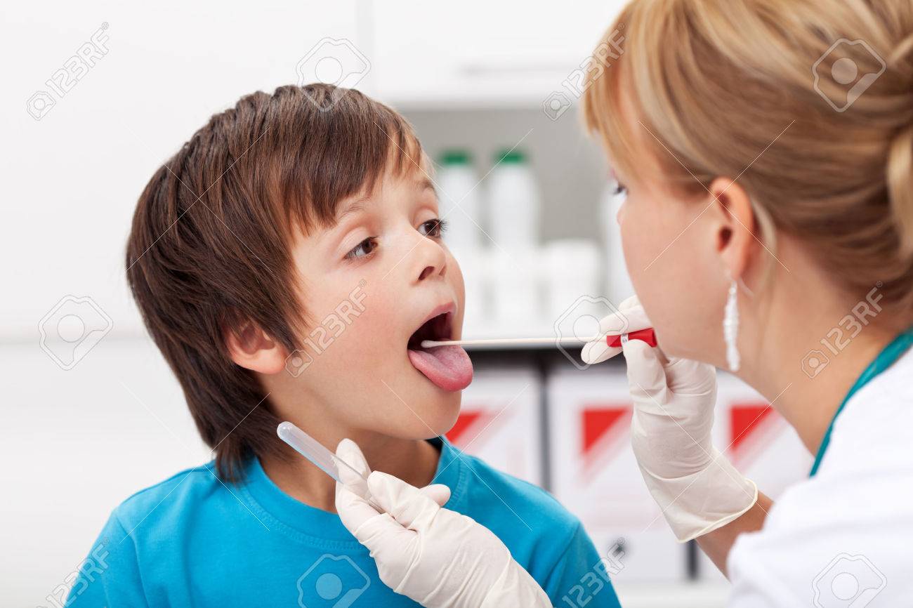 Boy at the doctor - a healthcare professional taking biological samples for testing - 25210632 Boy at the doctor - a healthcare professional taking biological samples for testing - 25210632
