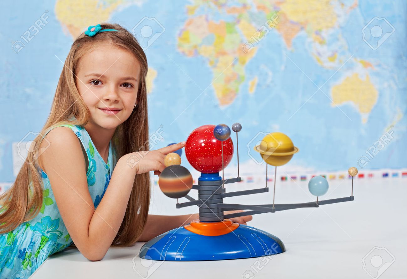 Young girl study solar system in geography science class using a scale model - 40086806 Young girl study solar system in geography science class using a scale model - 40086806