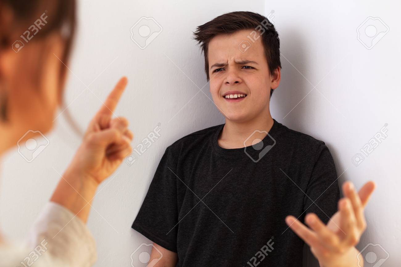 Woman having a fight with her teenager son - gesturing and expressing disagreement with each other - 119145981 Woman having a fight with her teenager son - gesturing and expressing disagreement with each other - 119145981