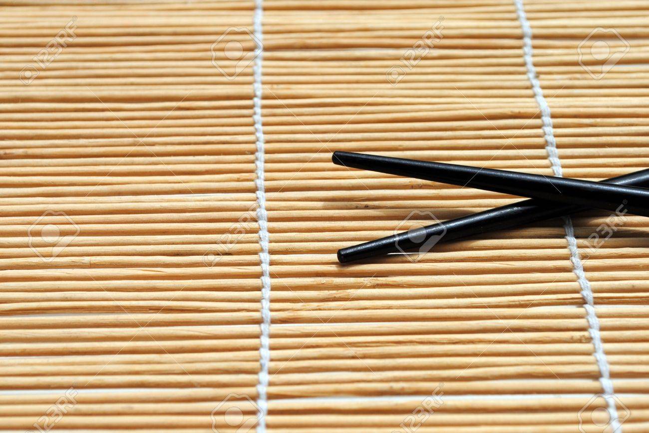 Japanese Chopsticks On Bamboo Placemat Background Stock Photo - Japanese Chopsticks On Bamboo Placemat Background Stock Photo japanese chopsticks on bamboo placemat background stock photo - japanese chopsticks on bamboo placemat background stock photo