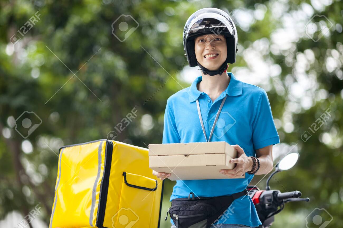 Delivery man carrying boxes of food - 126399746 Delivery man carrying boxes of food - 126399746