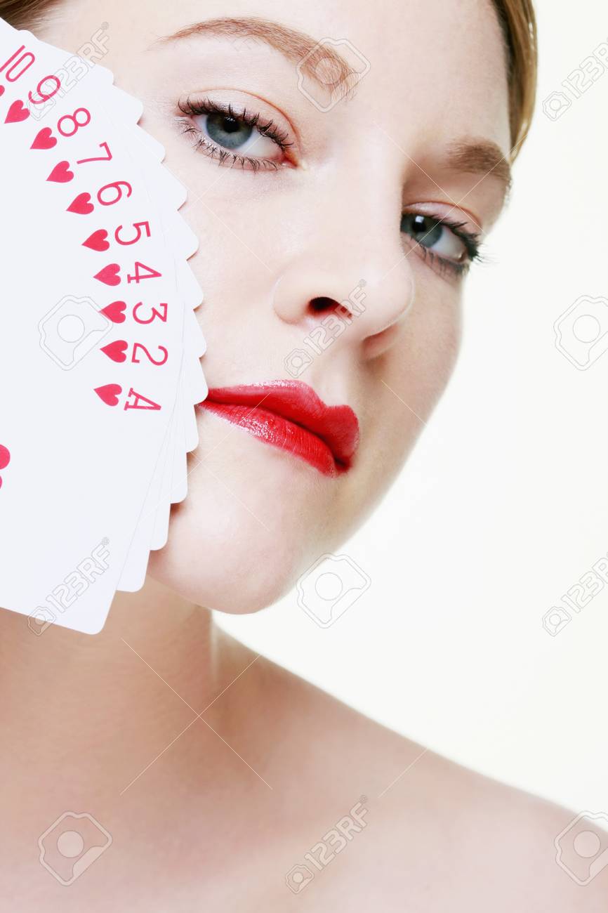 Woman with fanned out playing cards on her face - 9521407 Woman with fanned out playing cards on her face - 9521407