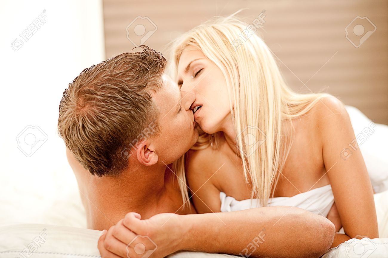 Intimate Lovers In Bed Kissing Each Other Stock Photo Picture And