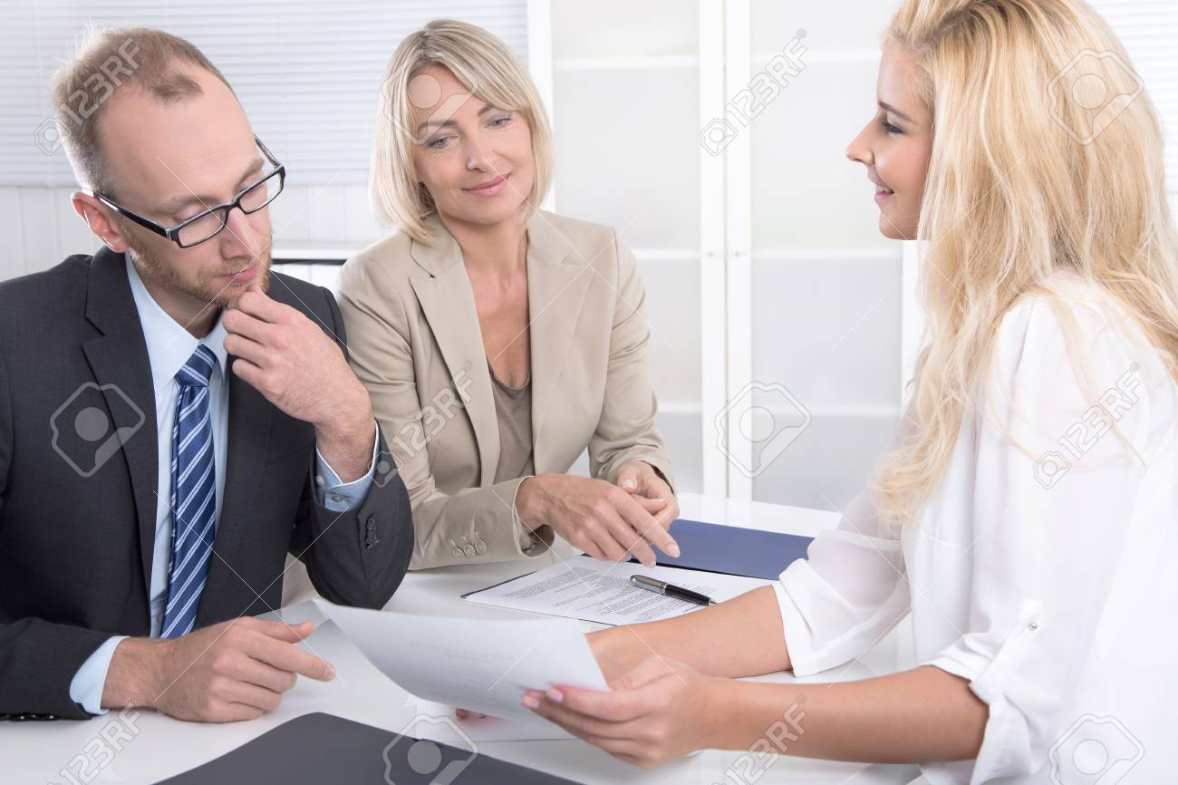 successful business team of man to woman sitting around a table
