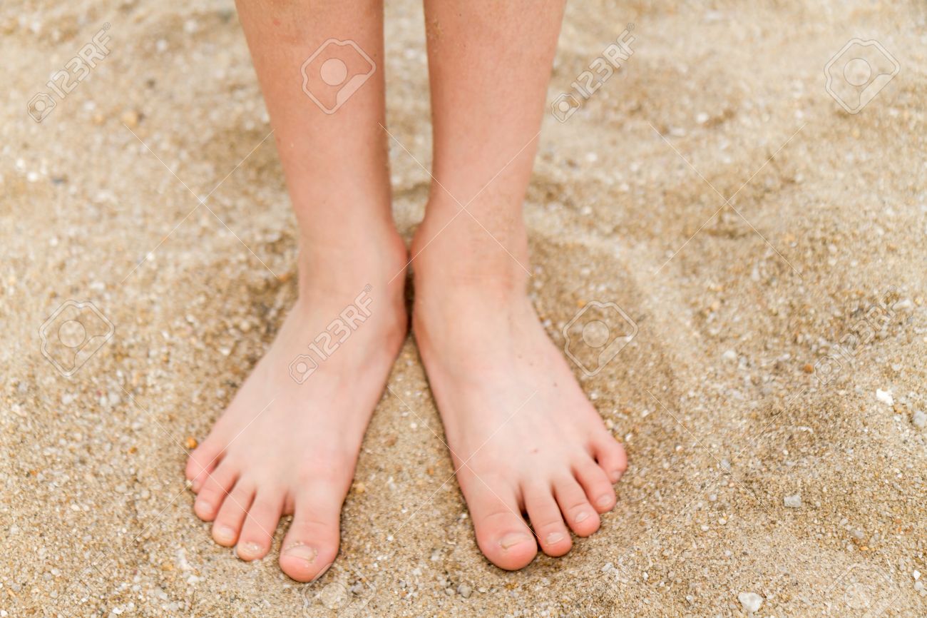 Bare feet of a young child in the sand - 31030205 Bare feet of a young child in the sand - 31030205