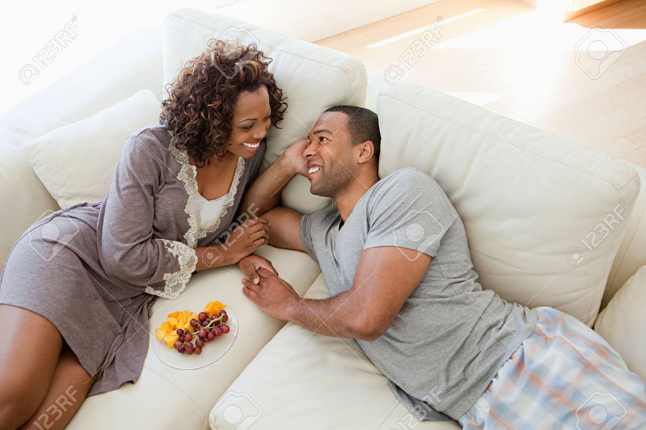 Young couple relaxing on sofa - 86036734 Young couple relaxing on sofa - 86036734