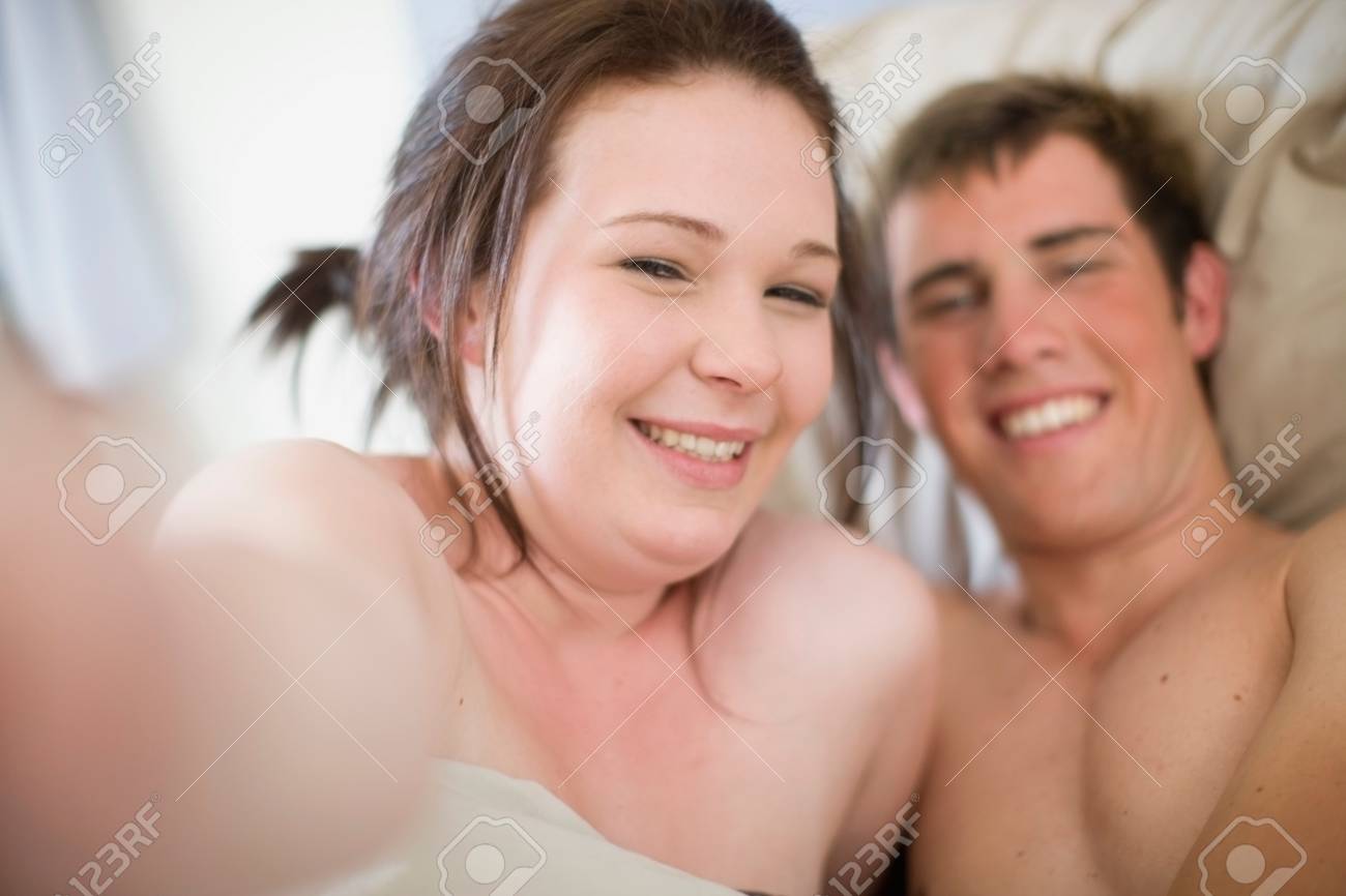 young nudist couples Nude Teenage Couple In Bed Together Stock Photo, Picture and Royalty Free  Image. Image 113868486.