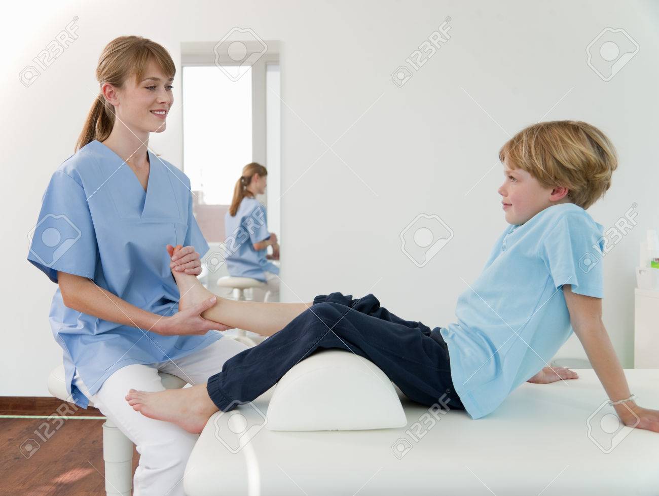 Doctor Examining Boys Feet In Office Stock Photo 80359436 Doctor Examining Boys Feet In Office Stock Photo 80359436