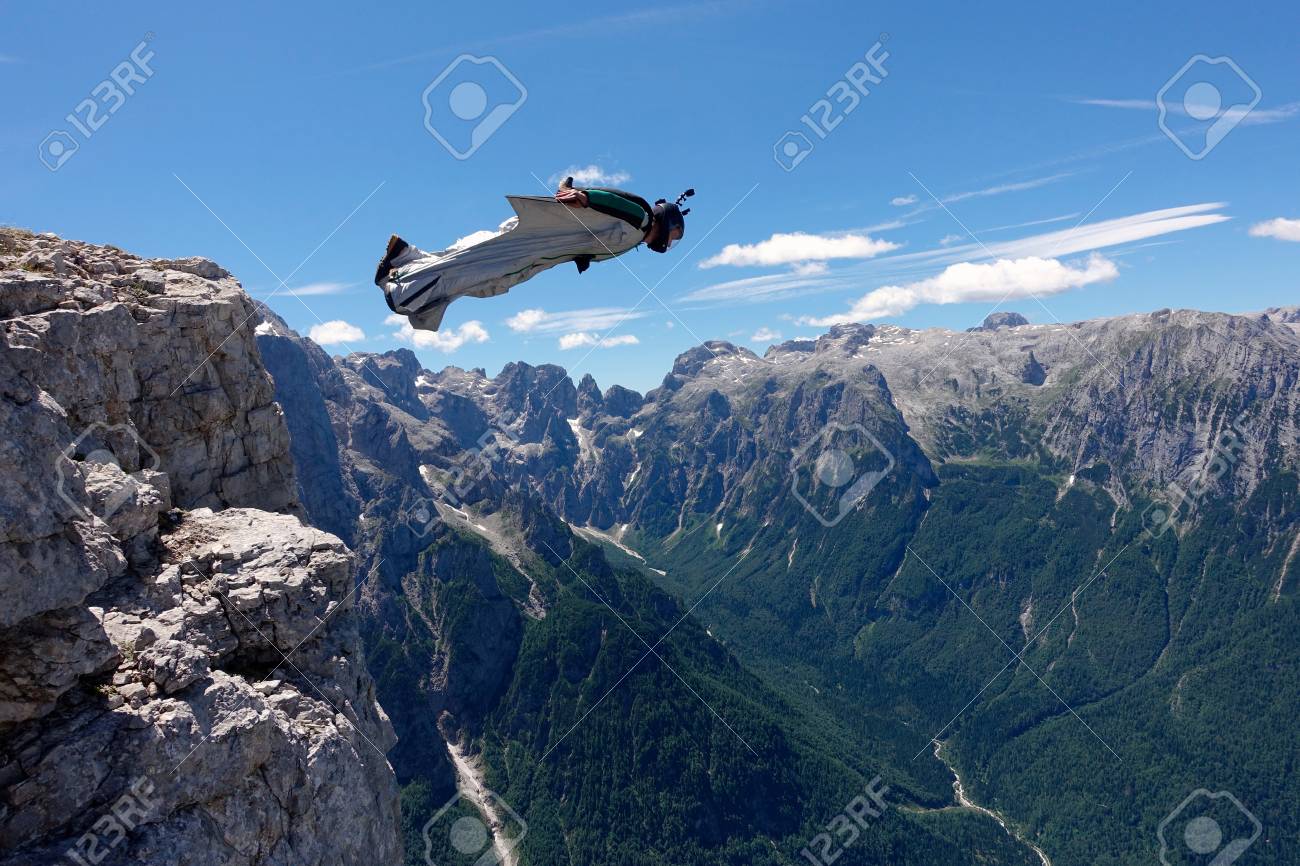 Wingsuit Base Jumper Is Flying From A Cliff Italian Alps Alleghe