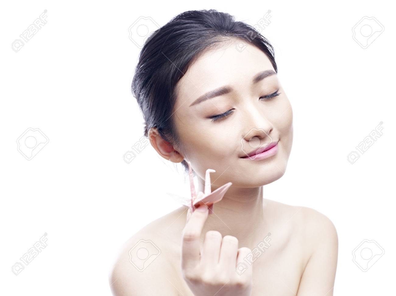 Young And Beautiful Asian Woman Holding A Paper Crane Eyes Closed