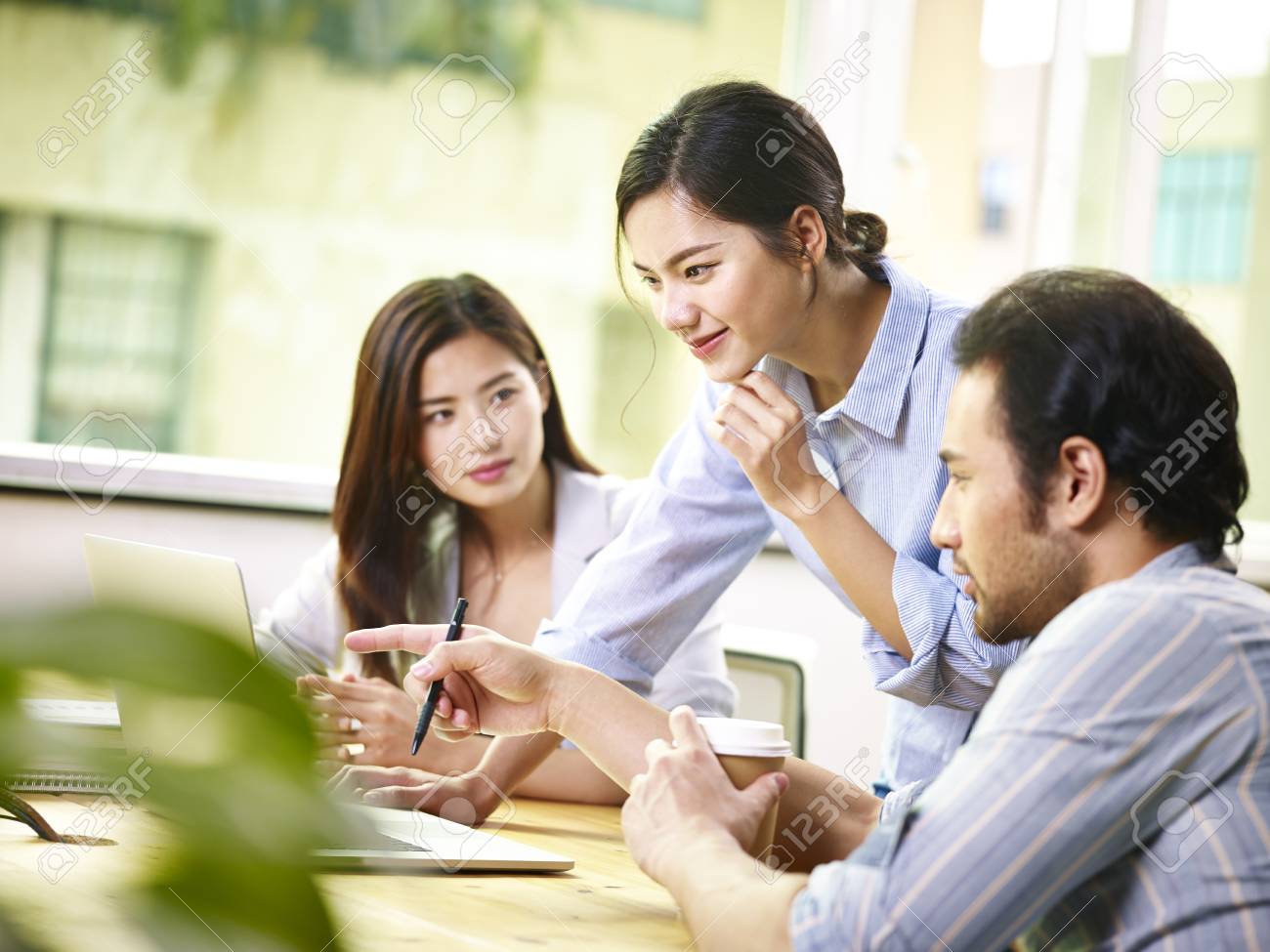 team of young asian business people in casual wear working together in office using laptop computer. - 91514231 team of young asian business people in casual wear working together in office using laptop computer. - 91514231