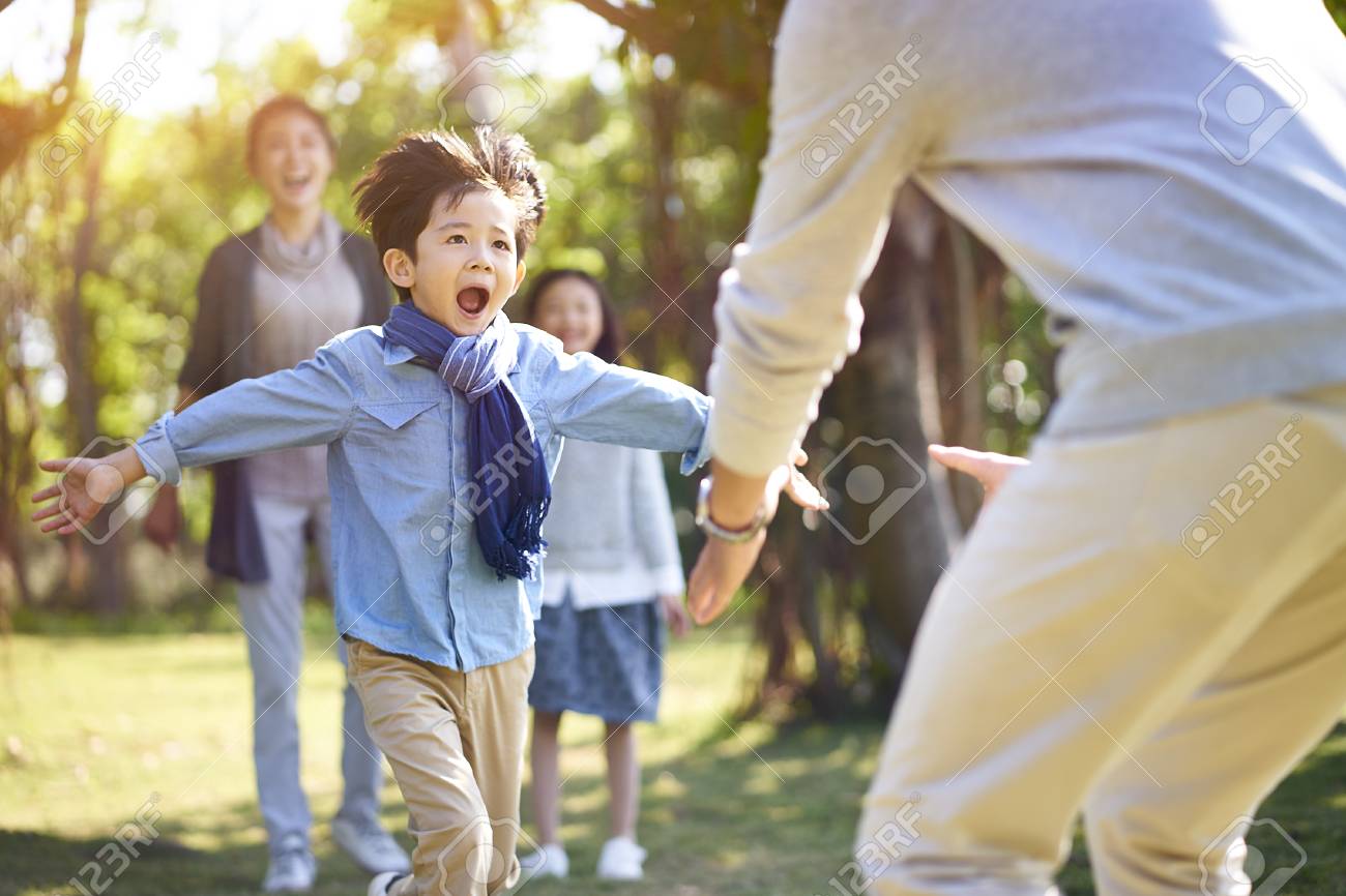 asian little boy son running towards father's embrace. - 115663134 asian little boy son running towards father's embrace. - 115663134