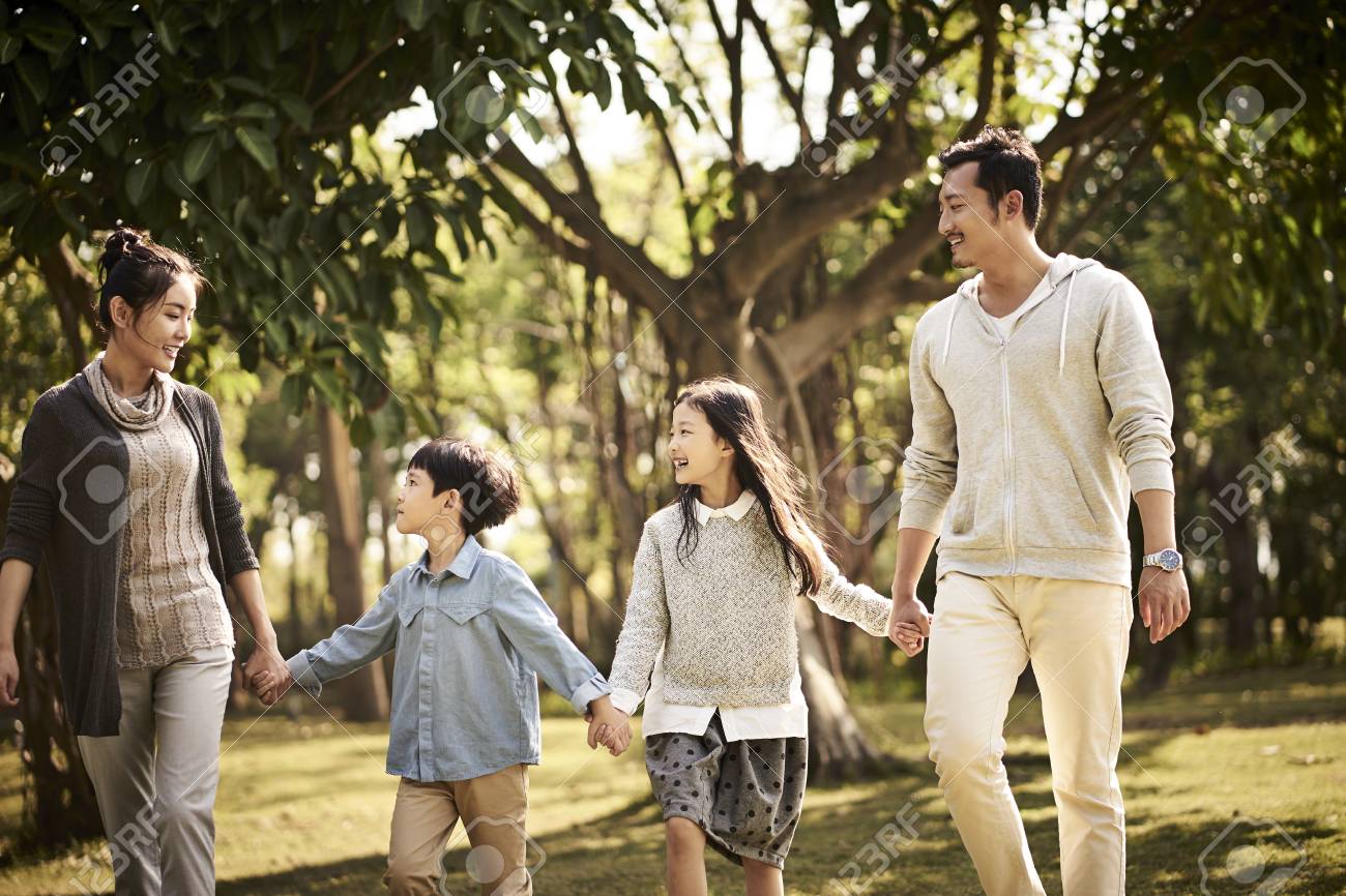 asian family with two children walking relaxing in park happy and smiling. - 115990633 asian family with two children walking relaxing in park happy and smiling. - 115990633