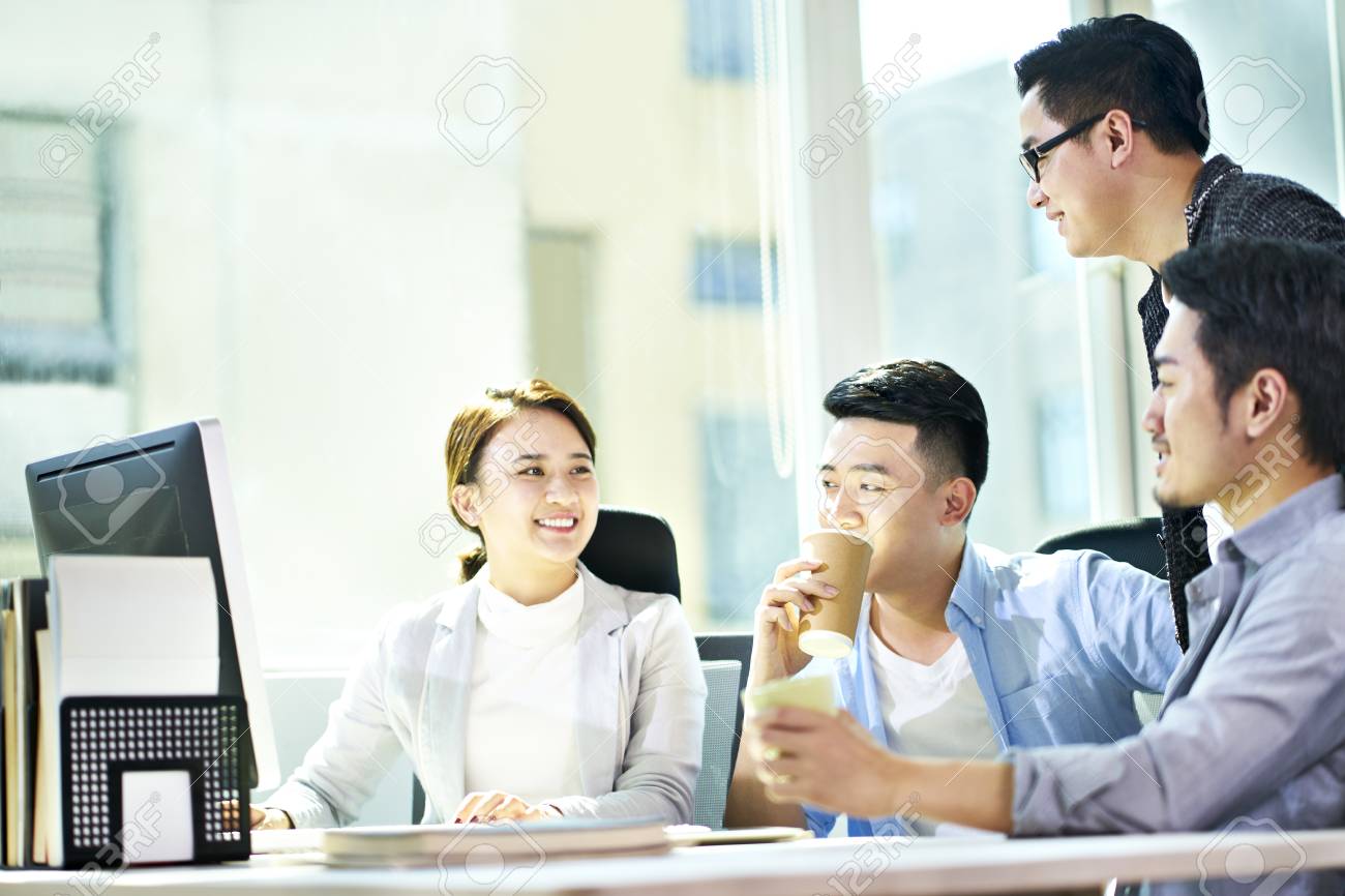 four young asian businesspeople meeting in office discussing business plan using tablet PC. - 119594997 four young asian businesspeople meeting in office discussing business plan using tablet PC. - 119594997