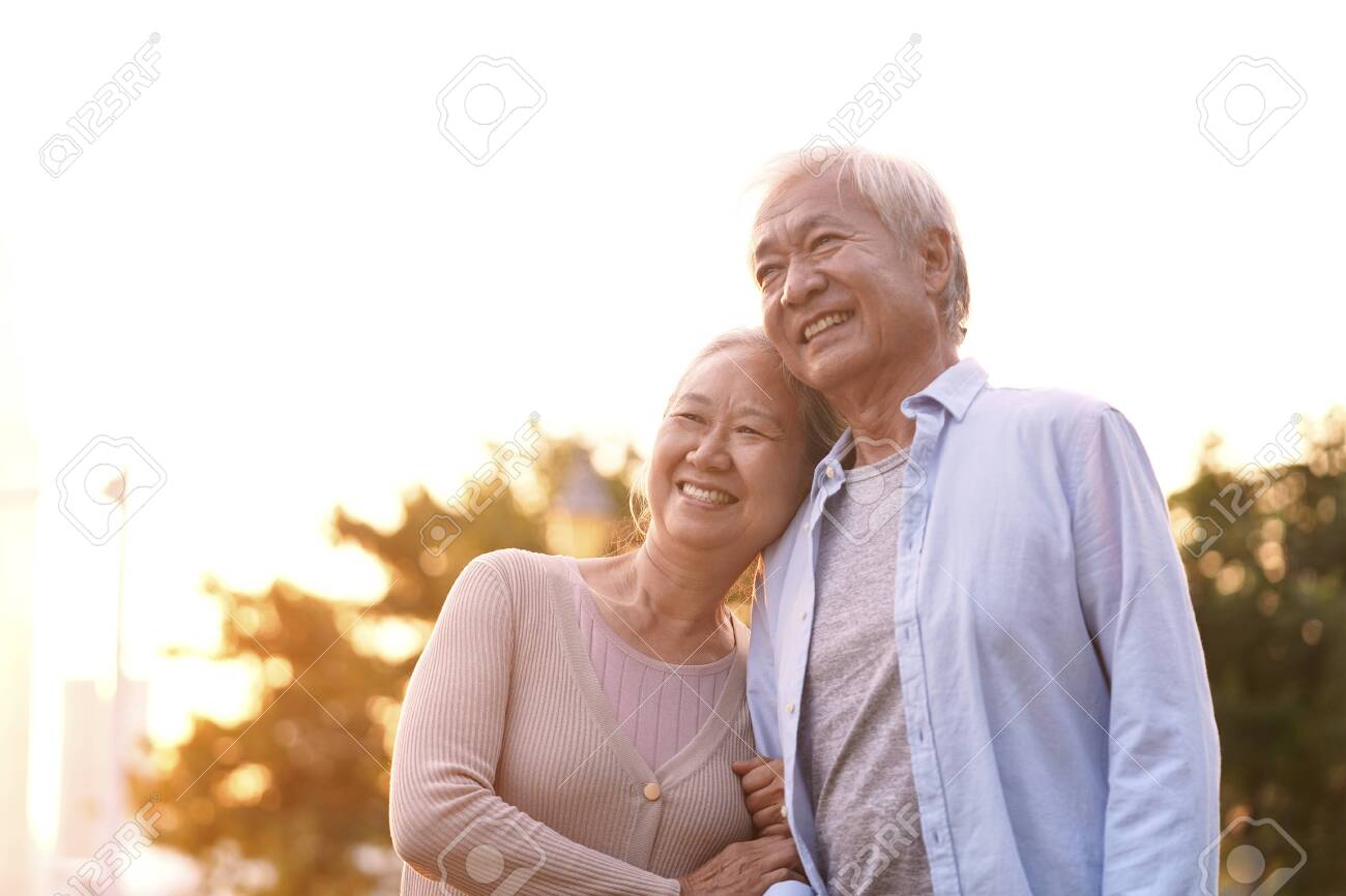 outdoor portrait of loving senior asian couple, happy and smiling - 134198977 outdoor portrait of loving senior asian couple, happy and smiling - 134198977