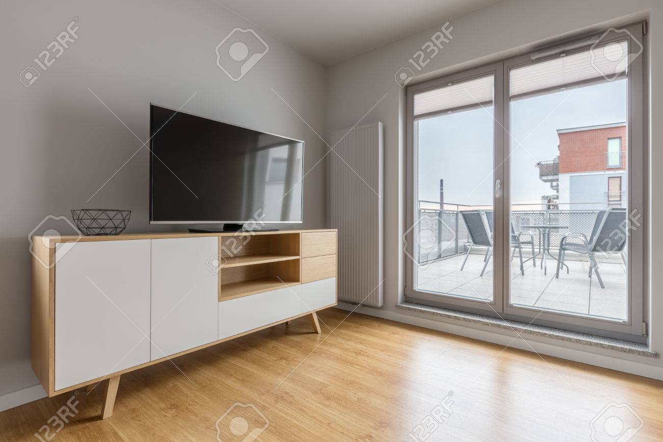 Grey Tv Living Room With Simple Cabinet Floor Panels And Balcony Stock Photo Picture And Royalty Free Image Image 75201662