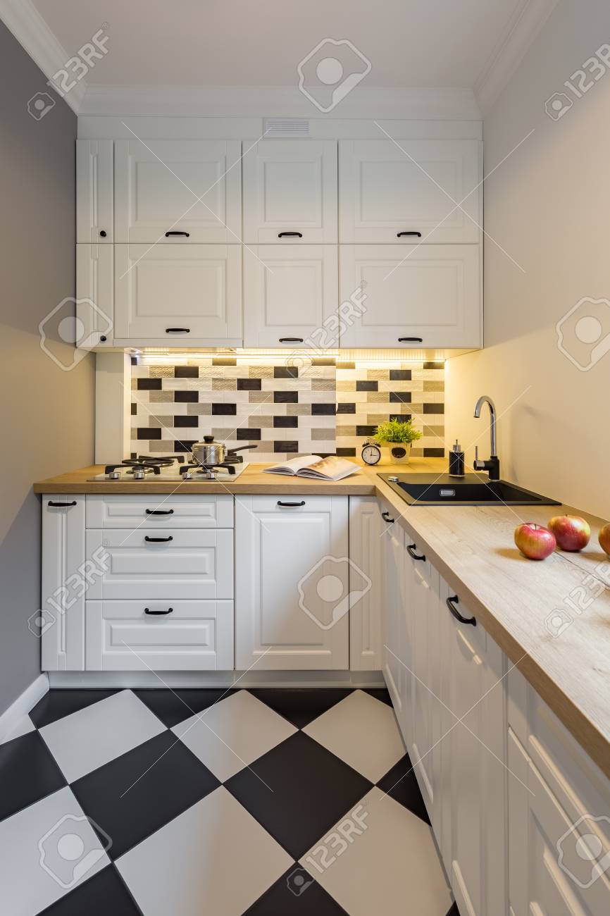 Small Kitchen With Modern Black And White Floor Tiles Stock Photo