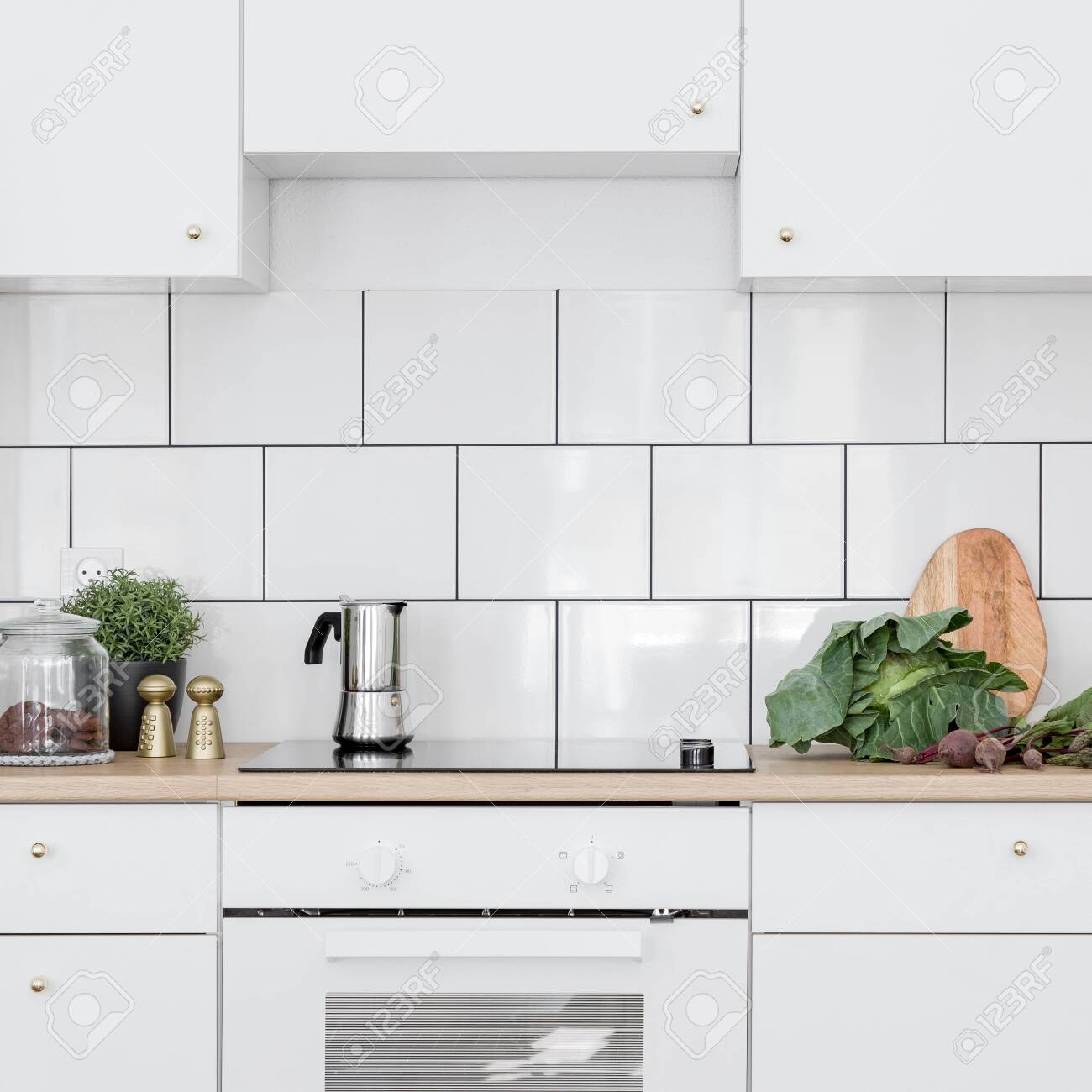 White Kitchen With Classic Wall Tiles Simple Cupboards And Induction Stock Photo Picture And Royalty Free Image Image 132364702