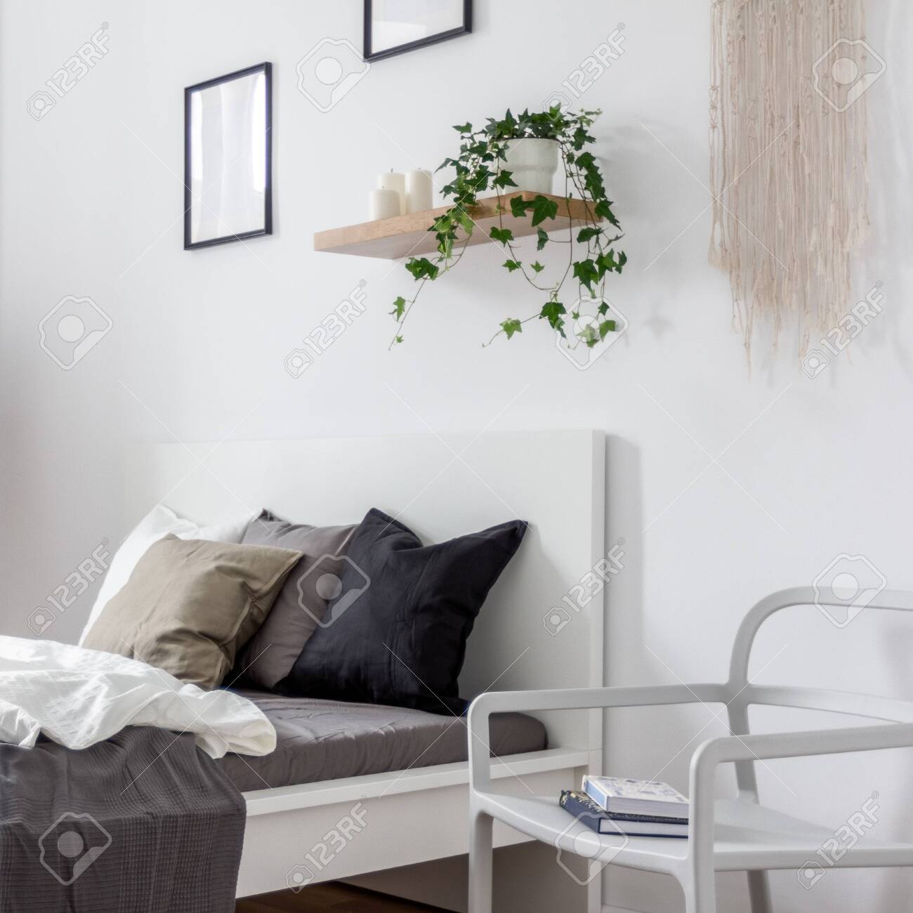 Bedroom With Simple White Chair Single Bed And Wooden Wall Shelf Stock Photo Picture And Royalty Free Image Image