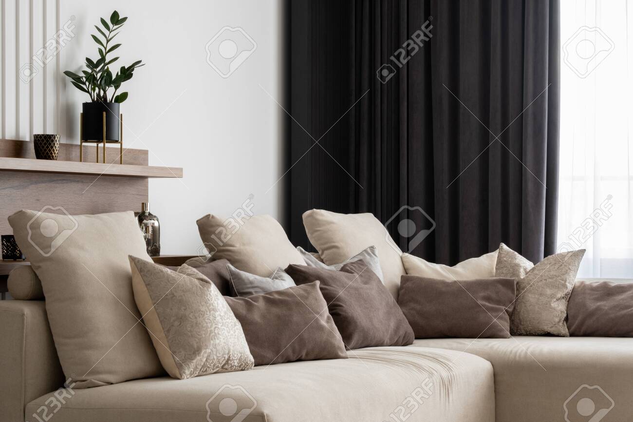 beige couch with pillows