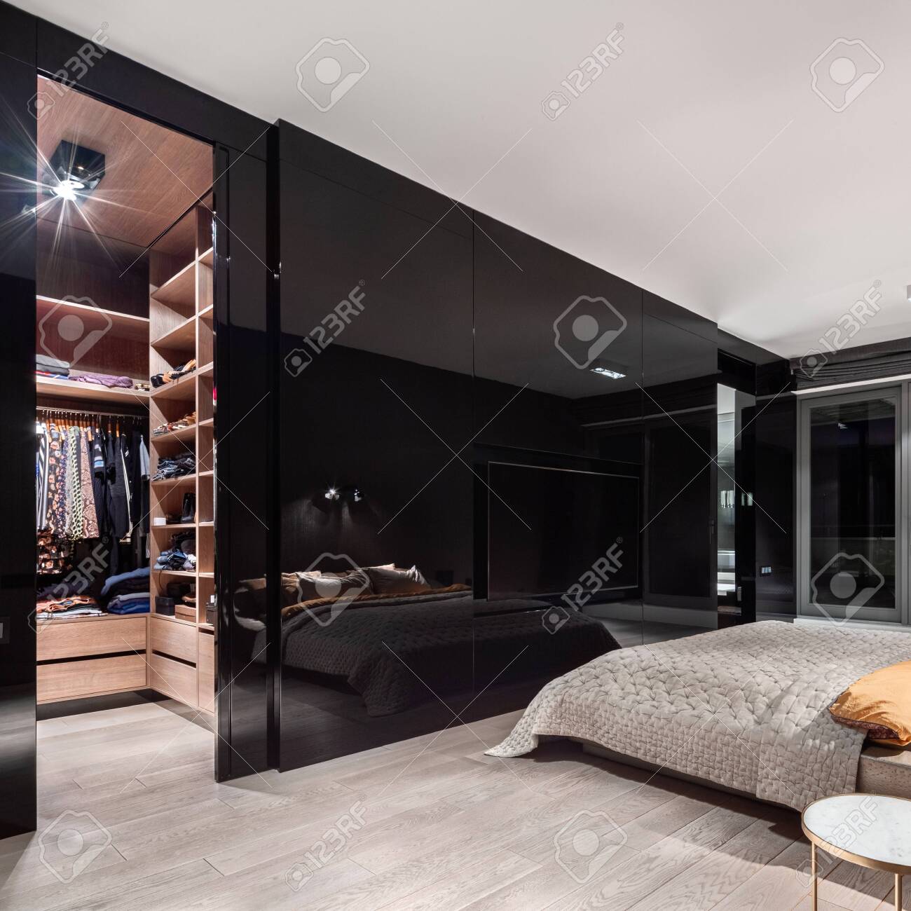 Luxury Bedroom With Walk In Closet With Wooden Shelves Behind Stylish, Black  And Mirrored Wall Stock Photo, Picture and Royalty Free Image. Image  157526611., image size:1300x1300