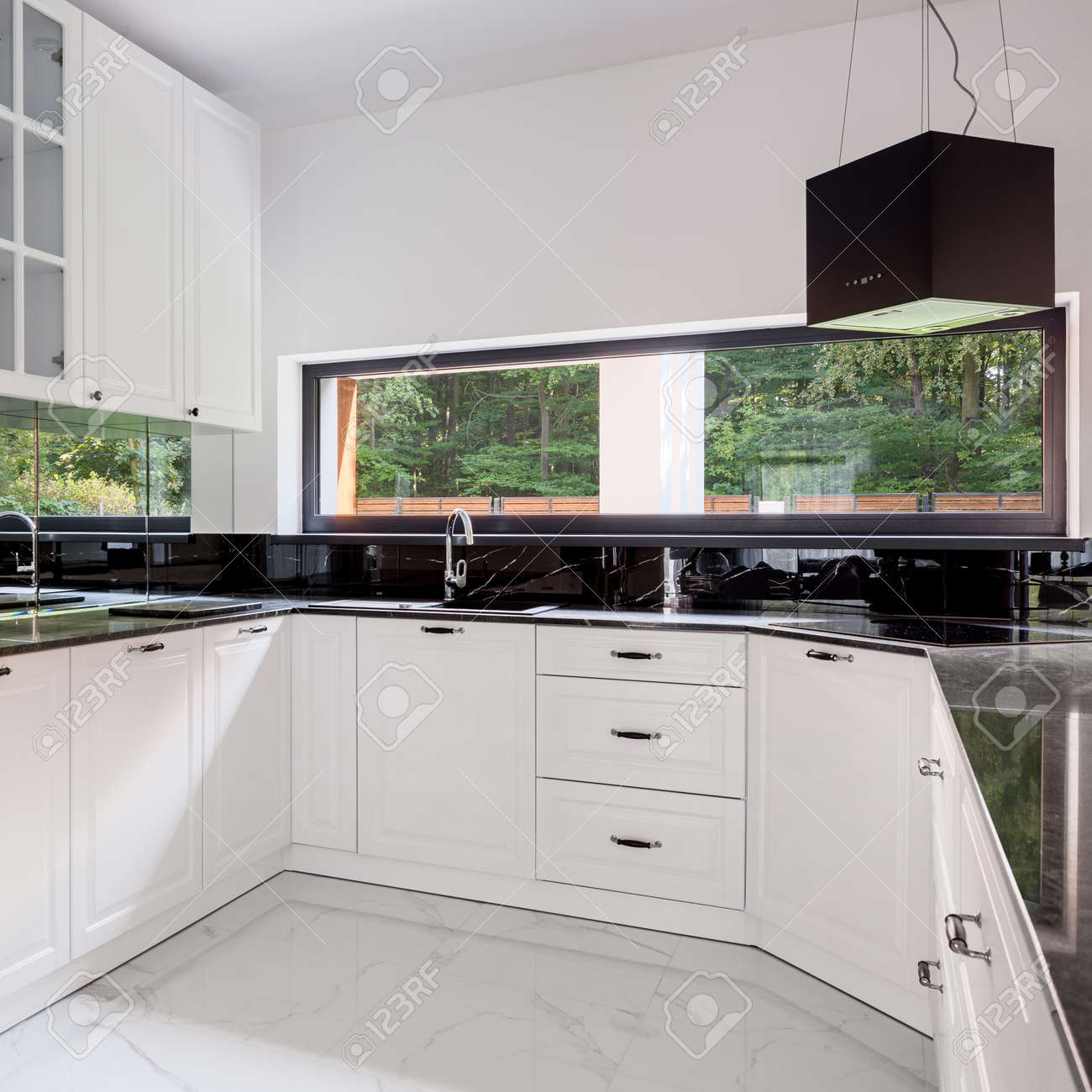 Black And White Kitchen With Long Window Marble Floor Tiles And Modern Black Kitchen Hood Stock Photo Picture And Royalty Free Image Image 159131789