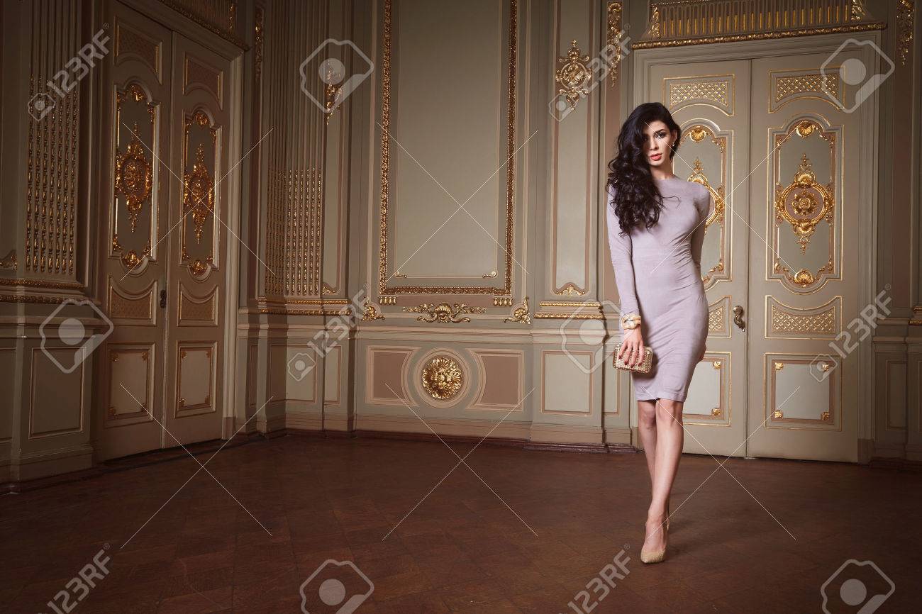 Beautiful woman in elegant dress fashionable autumn Collection of spring long brunette hair makeup tanned slim body figure accessories interior luxury castle gold monogram baroque palace of Queen - 48834918 Beautiful woman in elegant dress fashionable autumn Collection of spring long brunette hair makeup tanned slim body figure accessories interior luxury castle gold monogram baroque palace of Queen - 48834918