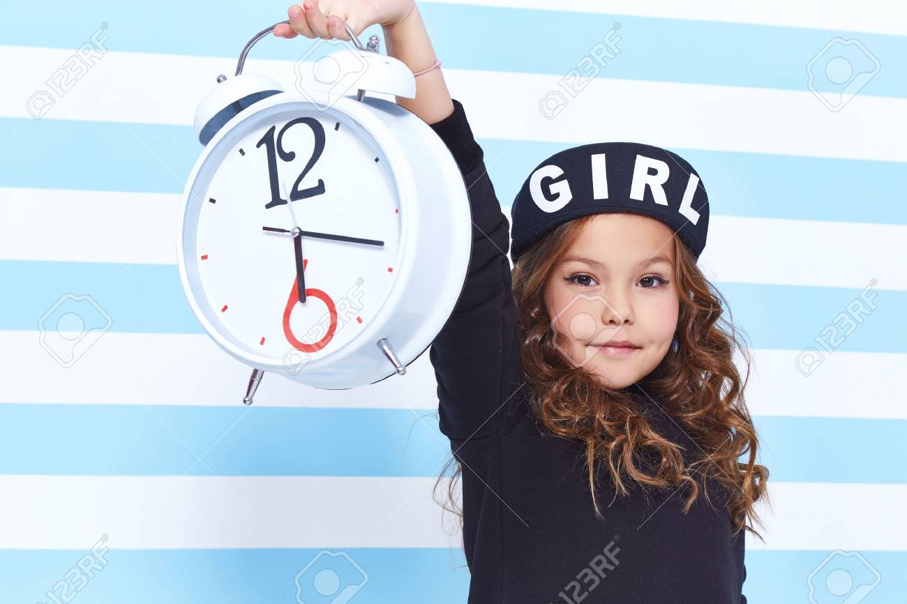 Beautiful Cute Pretty Little Girl Baby Blond Curly Hair Fun To Play Children Room Party Striped Background Wear Dress Style Fashion Clothes Winter Collection Watch Alarm Alice In Wonderland Daughter Stock Photo Beautiful Cute Pretty Little Girl Baby Blond Curly Hair Fun To Play Children Room Party Striped Background Wear Dress Style Fashion Clothes Winter Collection Watch Alarm Alice In Wonderland Daughter Stock Photo
