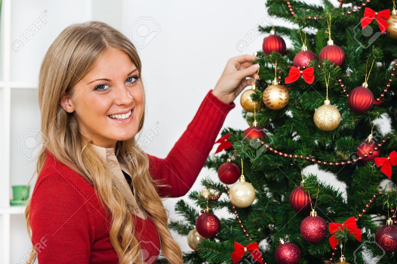 girl decorating christmas tree