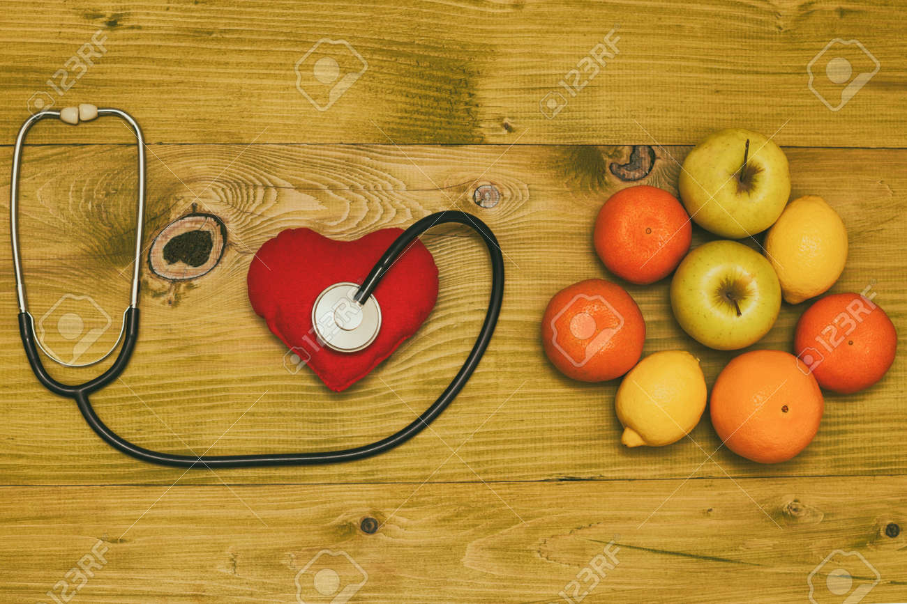Image of fruit,stethoscope and heart shape on wooden table.Toned photo. - 121351674 Image of fruit,stethoscope and heart shape on wooden table.Toned photo. - 121351674