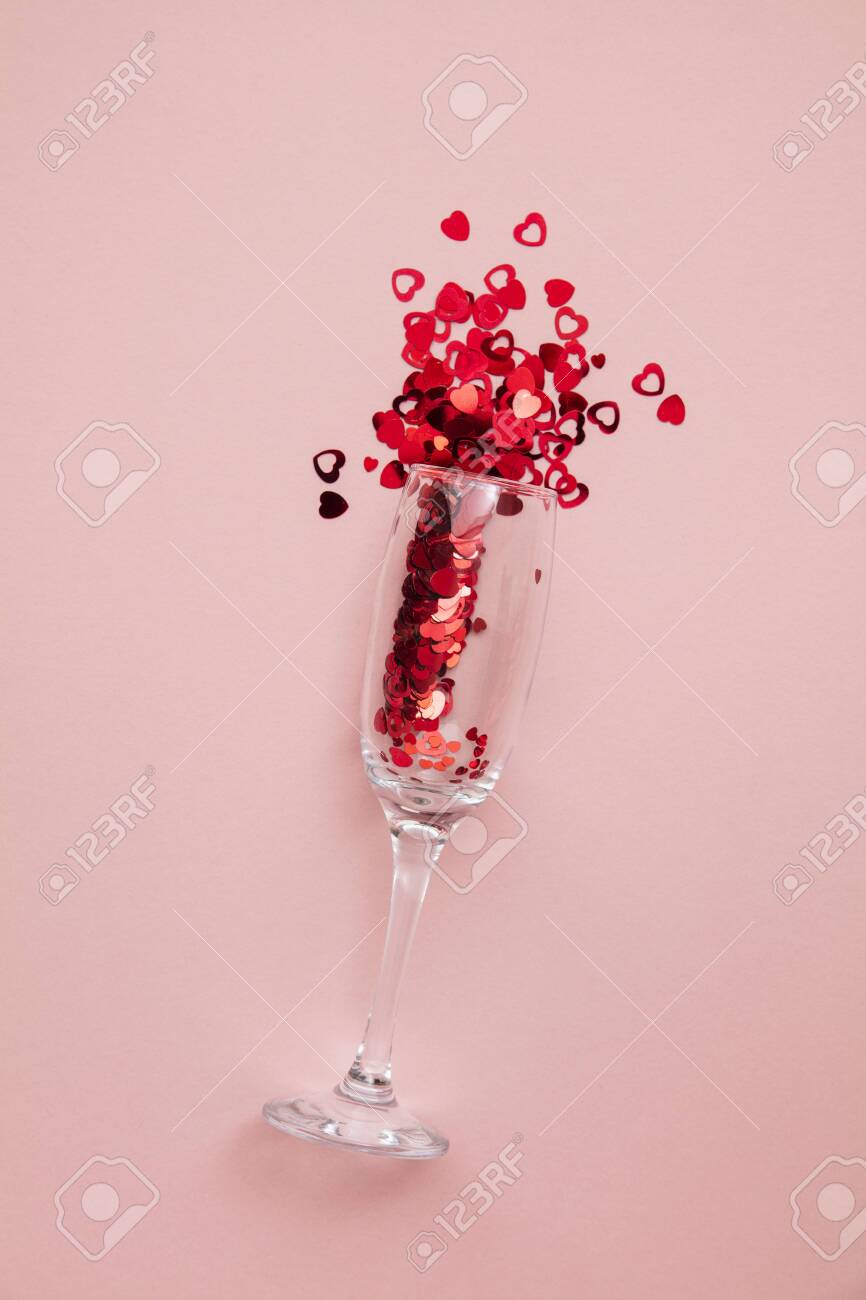 Valentine's day date night background. Drinks glasses with red heart confetti. - 139021569 Valentine's day date night background. Drinks glasses with red heart confetti. - 139021569