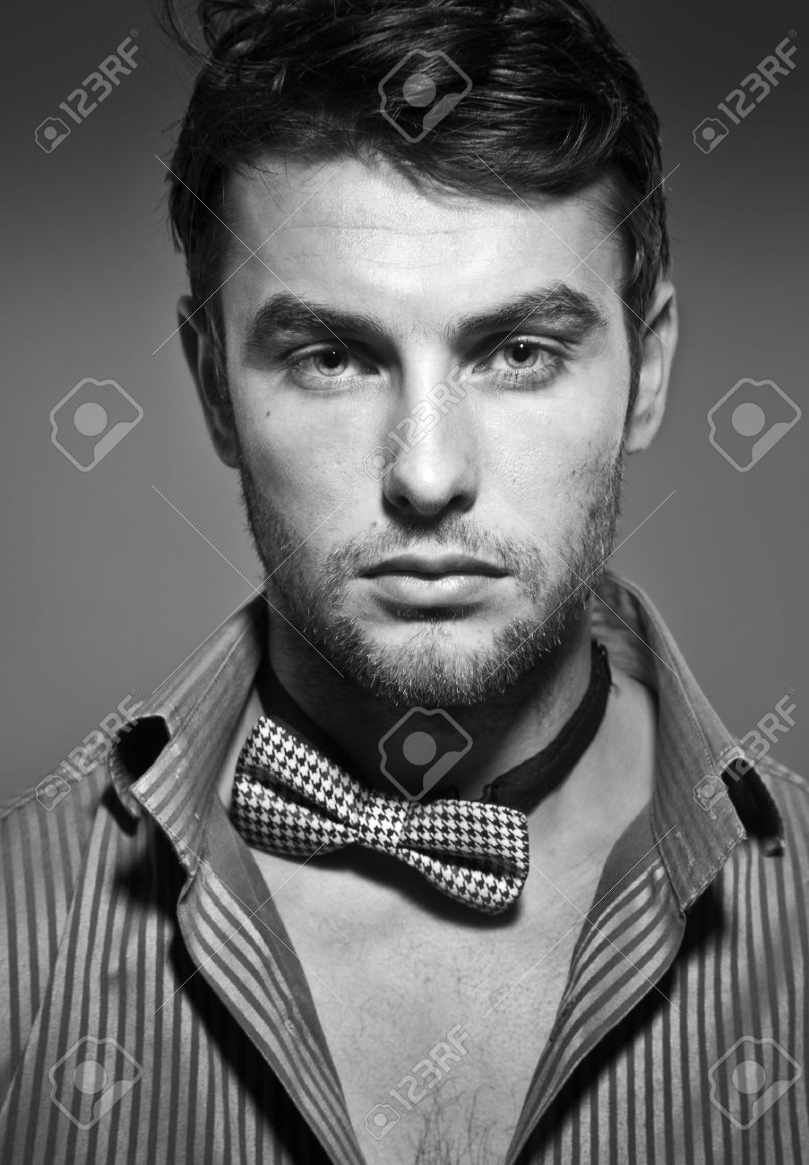 Stock photo young serious man close up black and white photo