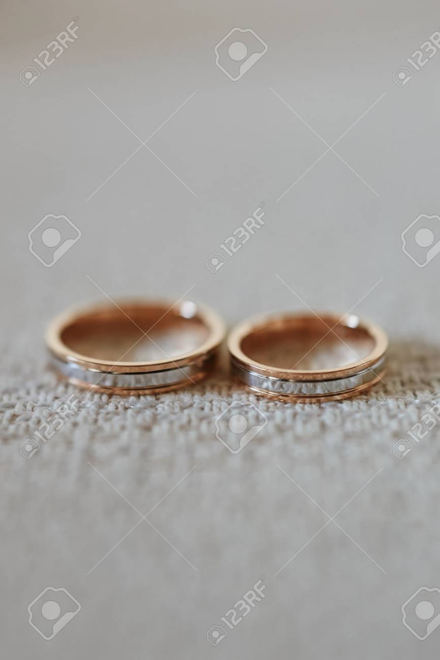 Close up view of stylish gold wedding rings on the textile. - 117879697 Close up view of stylish gold wedding rings on the textile. - 117879697
