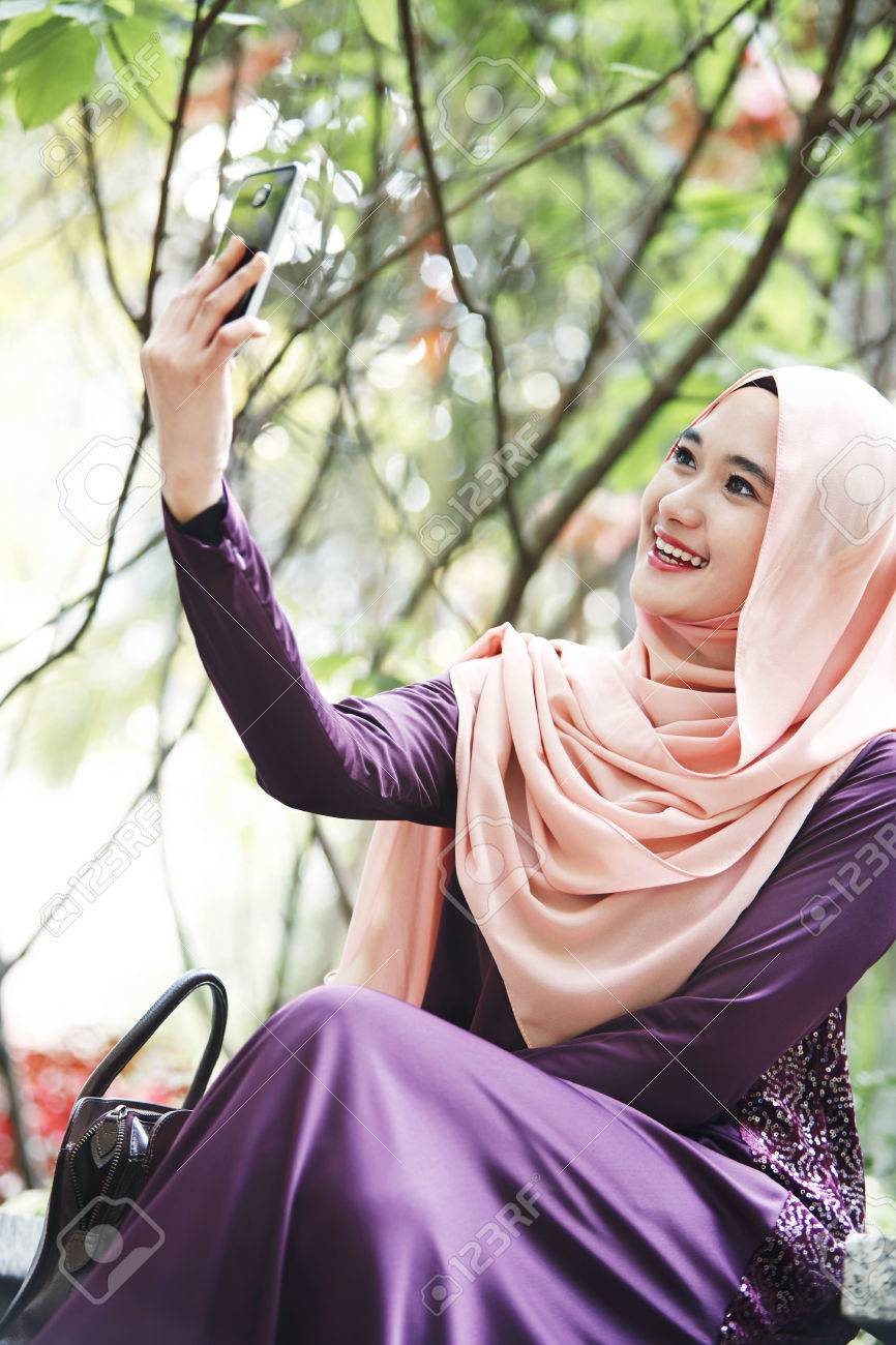 Smiling Young Malay Woman Taking Selfie At A Park Stock Photo Picture And Royalty Free Image Image 80135185
