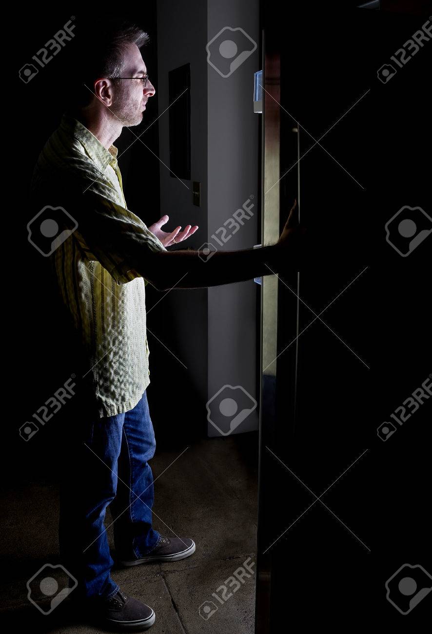 Man Looking For Food In An Open Fridge In A Dark Kitchen Late At Night  Stock Photo, Picture and Royalty Free Image. Image 59220260., image size:886x1300