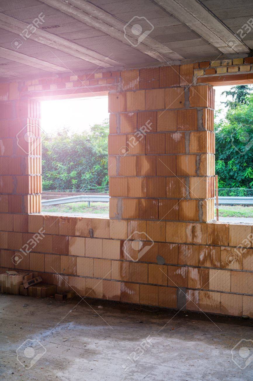 unfinished brick house interior with big windows. stock photo unfinished brick house interior with big windows. stock photo
