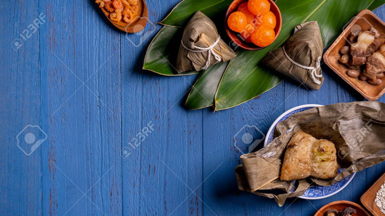 Rice dumpling, zongzi - Traditional Chinese food on blue wooden background of Dragon Boat Festival, Duanwu Festival, top view, flat lay design concept. - 147247229 Rice dumpling, zongzi - Traditional Chinese food on blue wooden background of Dragon Boat Festival, Duanwu Festival, top view, flat lay design concept. - 147247229