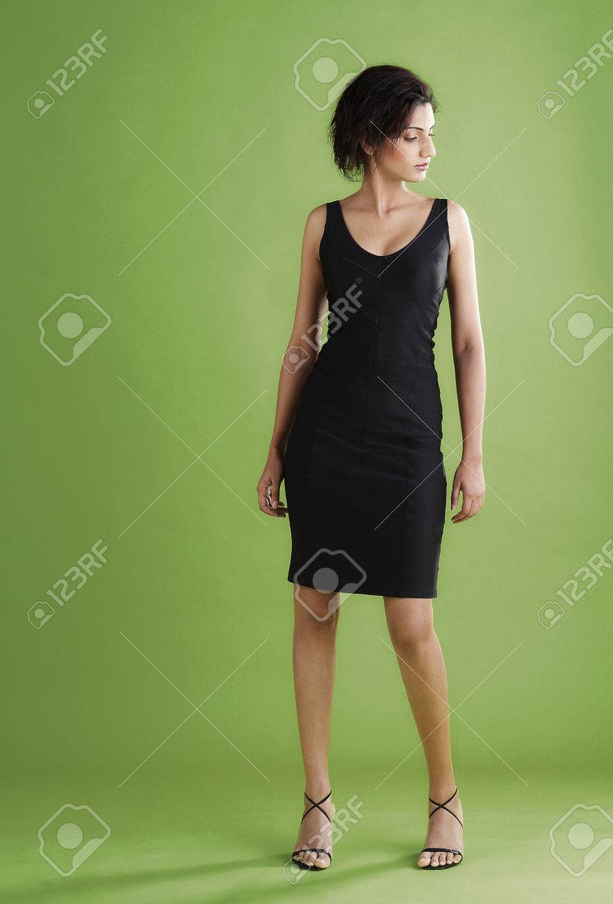 Studio Shot Of A Short Haired Lady In Black Dress And High Heels