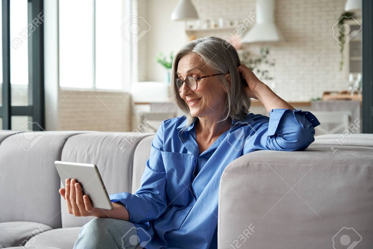 Happy 60s Mature Woman Calling Or image