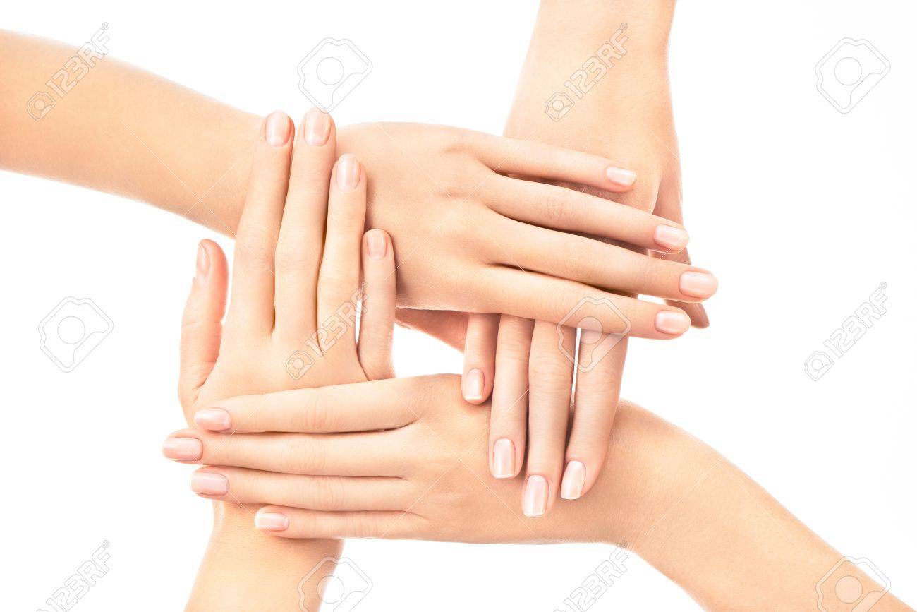 Four Female Hands Placed One Over Another With French Nail Design Four female hands placed one over another with french nail design on white background Stock Photo - Four Female Hands Placed One Over Another With French Nail Design