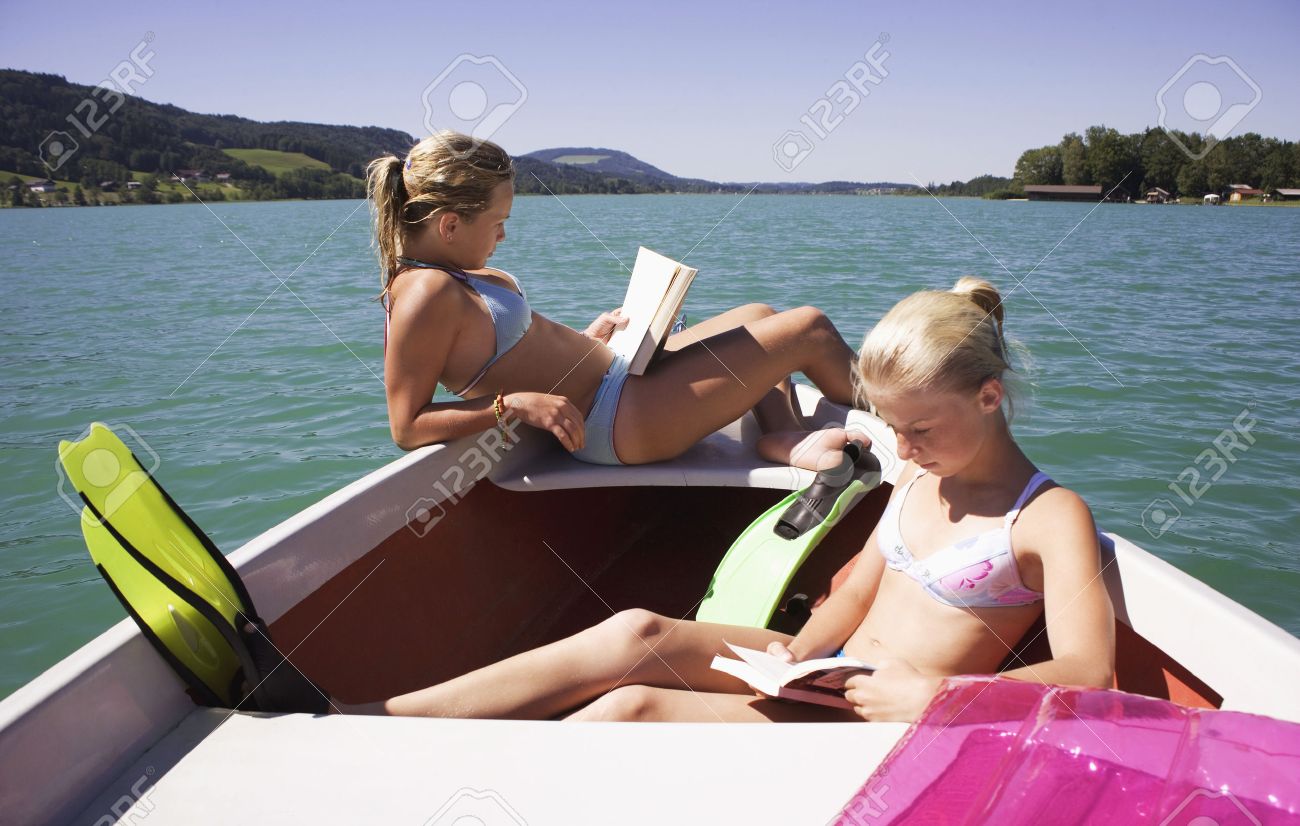 Worksheet Reading Boat girls 13 15 sitting on boat reading side view stock photo photo
