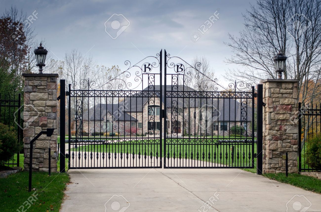 33622231-a-large-fancy-house-sits-behind-a-gated-entry-a-sign-of-privilege-and-money.jpg