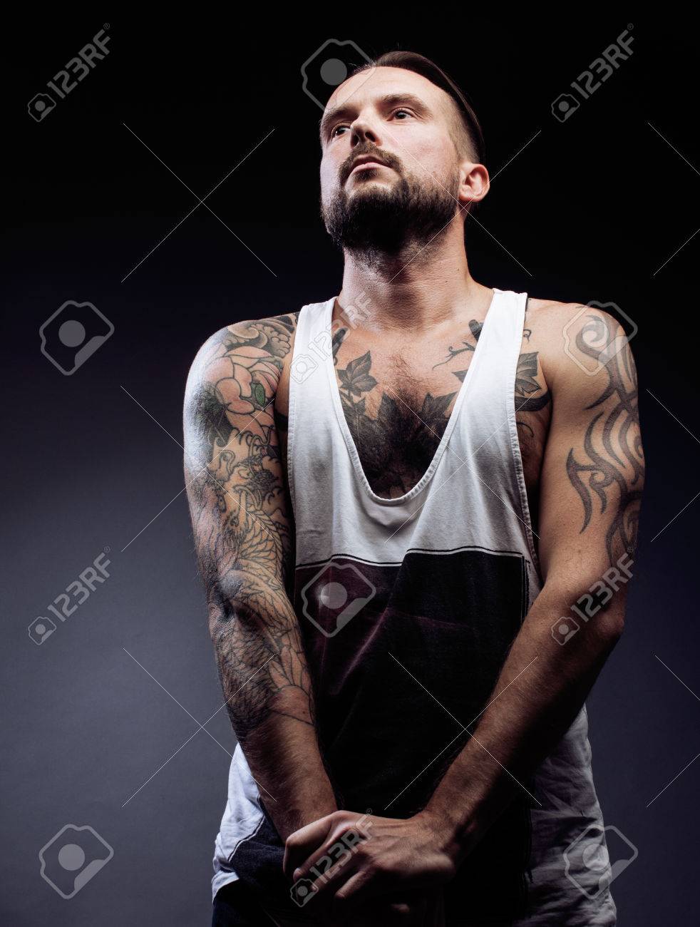 A Man With Tattooes On His Arms Silhouette Of Muscular Body