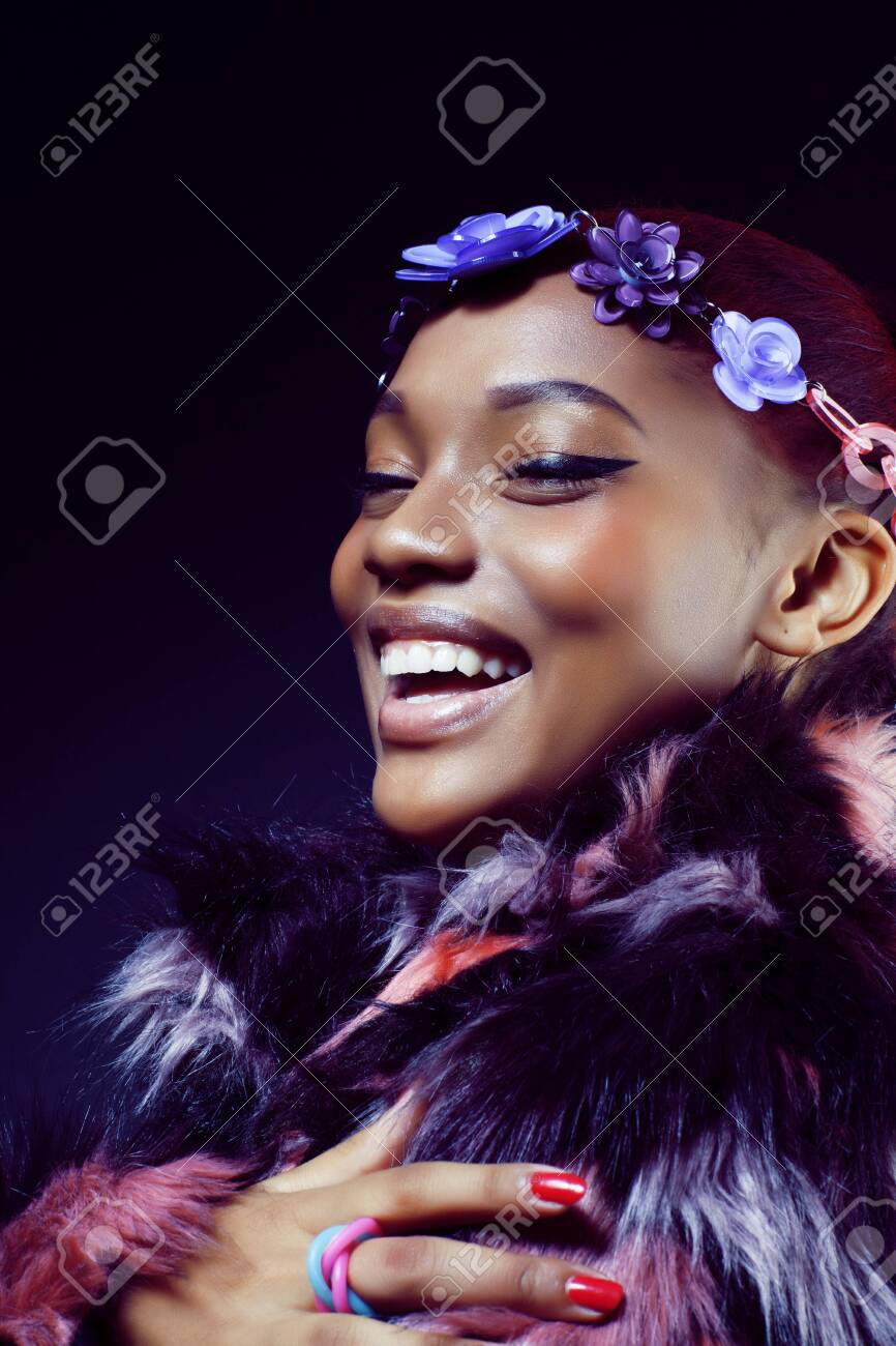 young pretty african american woman in spotted fur coat and flow - 130186466 young pretty african american woman in spotted fur coat and flow - 130186466