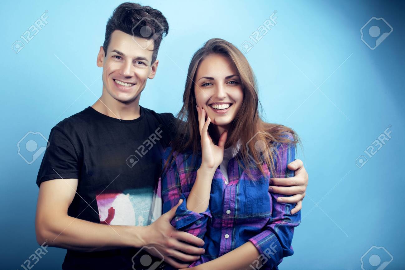 happy couple together posing cheerful on blue background , guy and girl students together friends - 132026708 happy couple together posing cheerful on blue background , guy and girl students together friends - 132026708