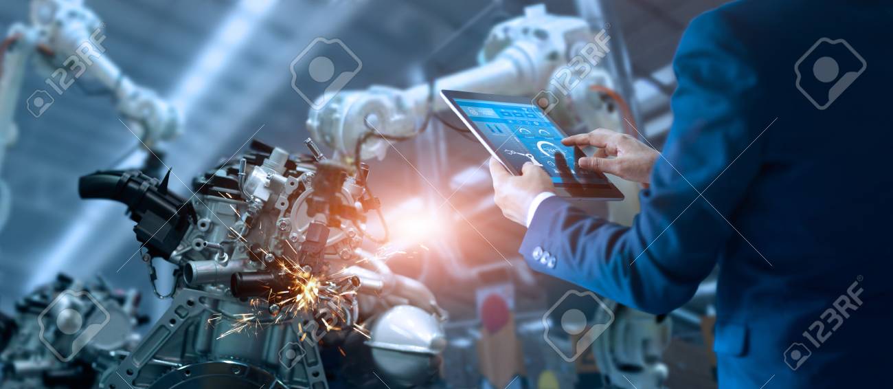 Manager engineer check and control automation robot arms machine in intelligent factory industrial on real time monitoring system software. Welding robotics and digital manufacturing operation. - 106927245 Manager engineer check and control automation robot arms machine in intelligent factory industrial on real time monitoring system software. Welding robotics and digital manufacturing operation. - 106927245