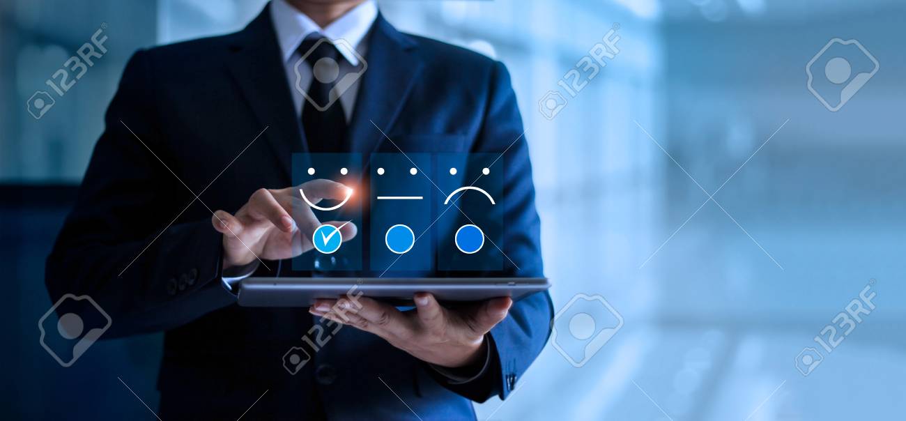Businessman touching and drawing face emoticon smile on the tablet, service mind. blue background. Customer service concept. - 126271314 Businessman touching and drawing face emoticon smile on the tablet, service mind. blue background. Customer service concept. - 126271314