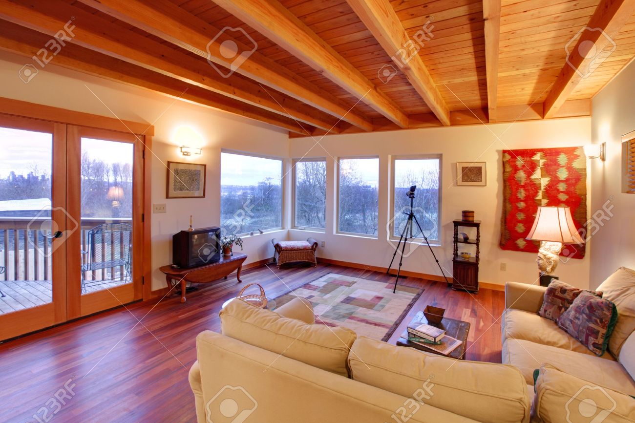 Modern luxury living room with wood ceiling and large windows ...