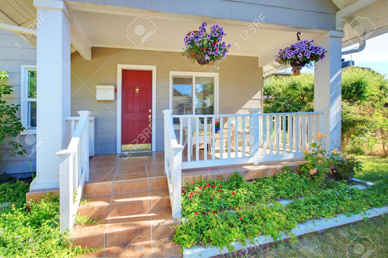 Red Door Grey House grey house porch with red door and white railings. stock photo Red Door Grey House grey house porch with red door and white railings. stock photo